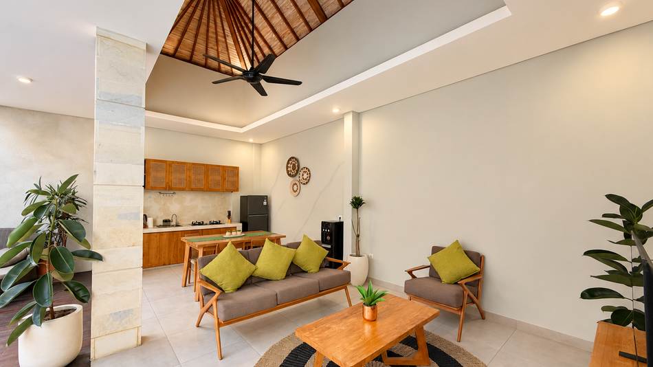 Living room with teak sofa and open kitchen
